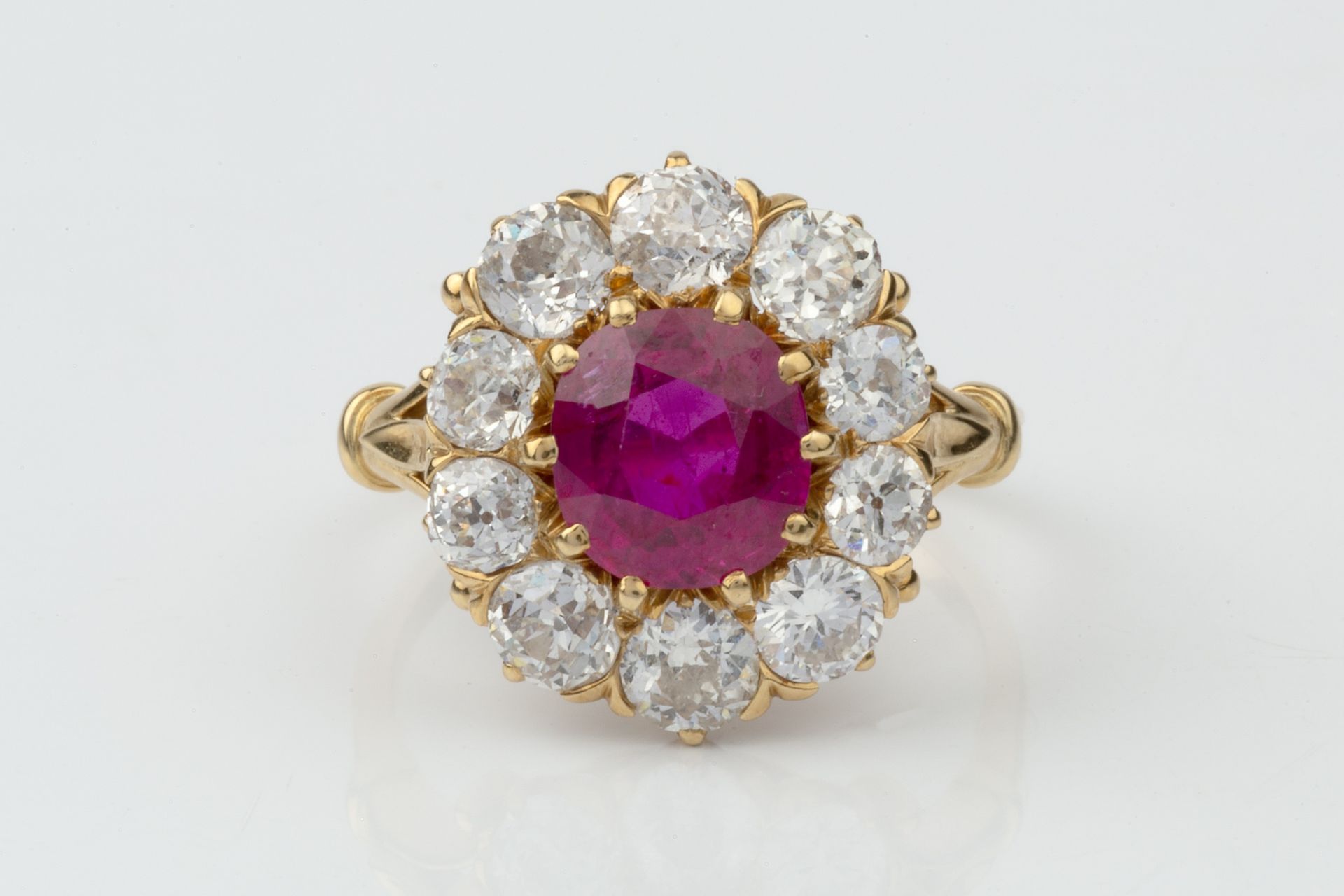 A ruby and diamond cluster ring, the central oval cut ruby within a border of ten old brilliant - Image 4 of 14