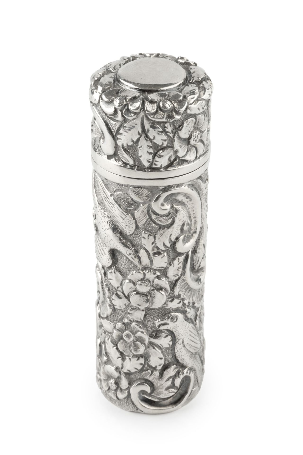A late Victorian silver scent bottle of cylindrical form, embossed and engraved with exotic birds