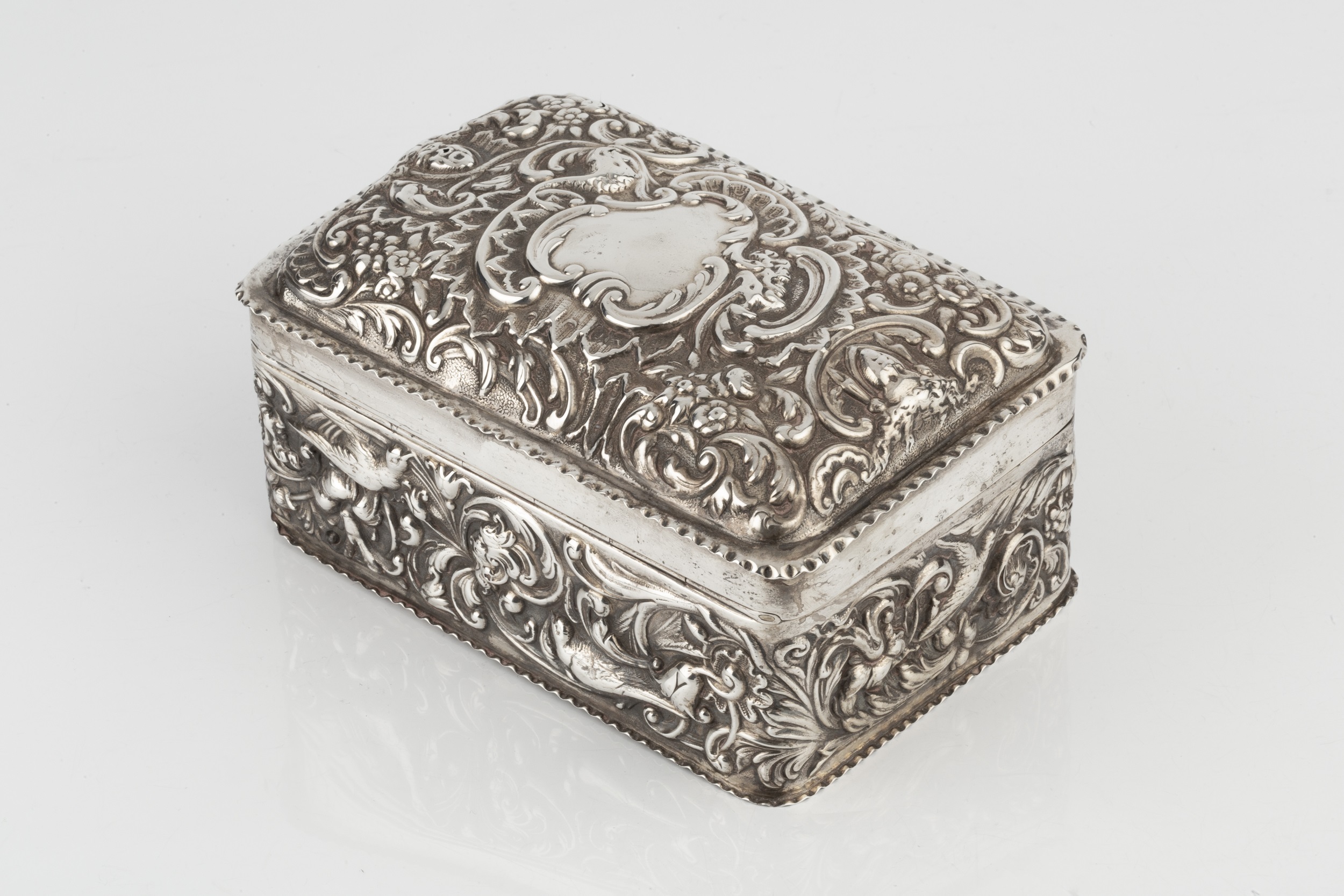 A late Victorian silver cigarette box, with domed hinged top, repoussé decorated with birds, flowers - Image 3 of 6