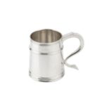 A silver pint mug, the tapered girdled body with reeded borders, and having shaped handle,