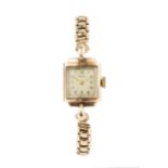A 9ct gold lady's Enicar wristwatch, with square silvered dial and stepped bezel, with 9ct gold