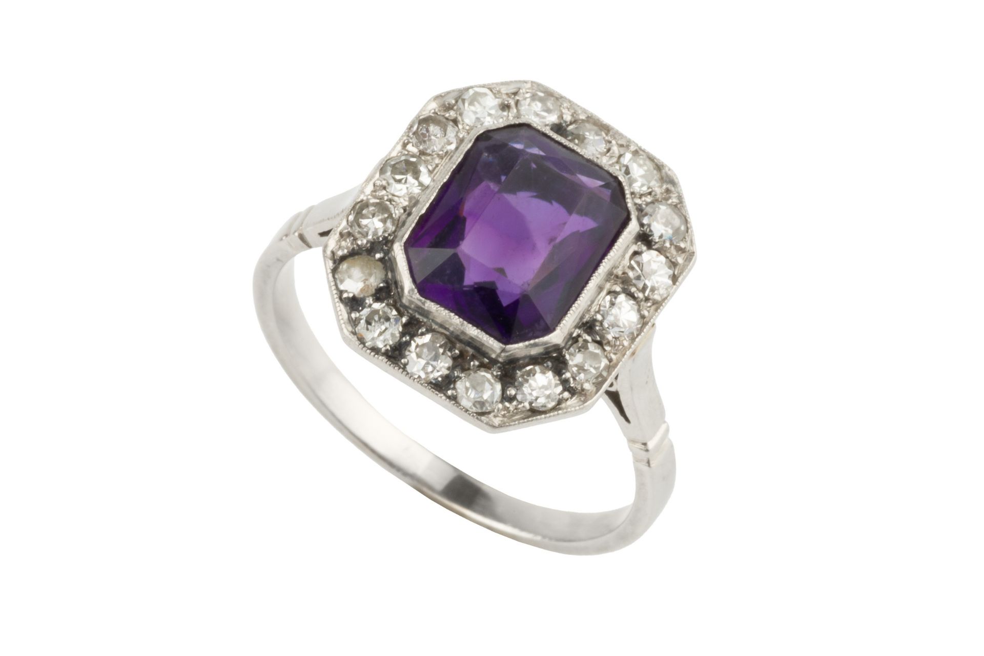 An amethyst and diamond cluster ring, the chamfered rectangular cut amethyst within a border of - Image 3 of 3