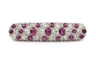 A ruby and diamond panel brooch, of slightly bowed and rounded rectangular design, set with three