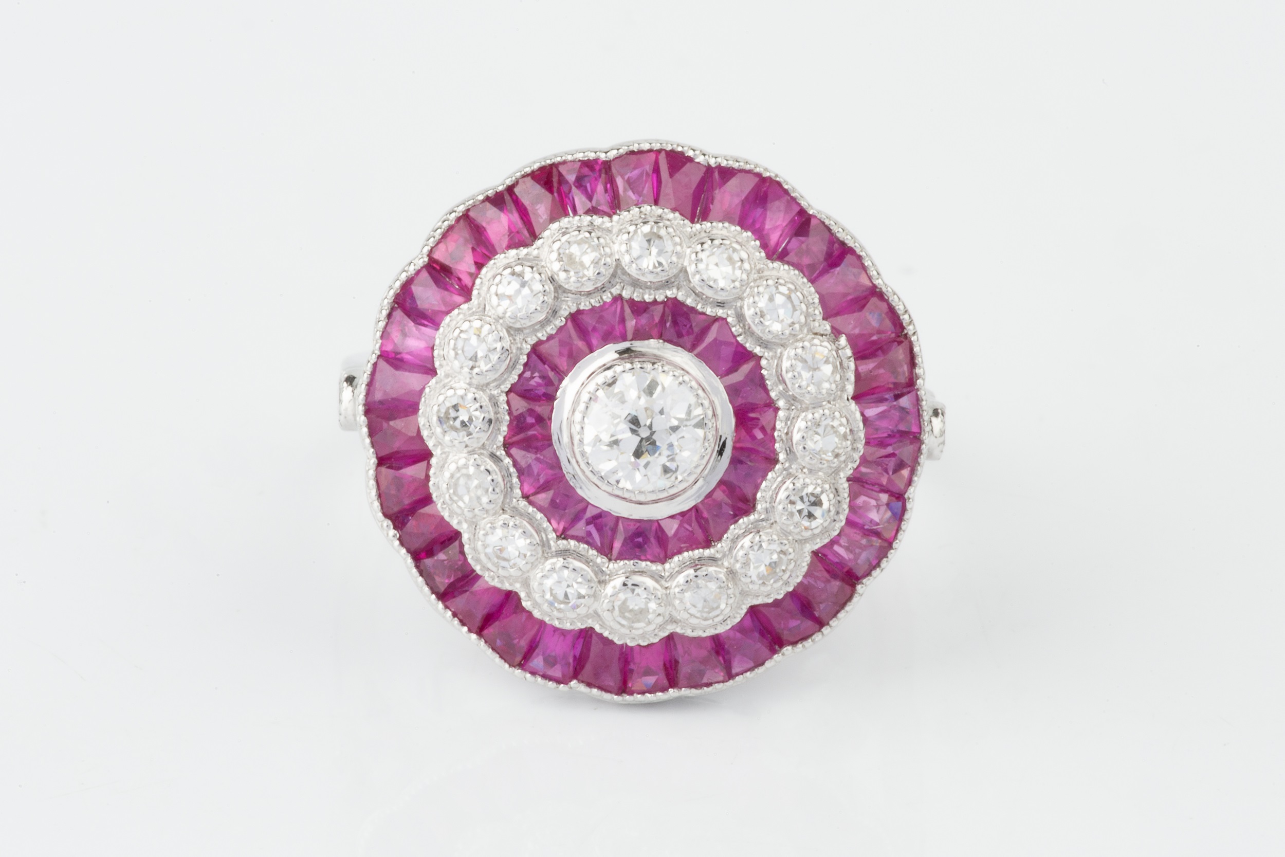 A ruby and diamond cocktail ring, of target design, centred with an old cut diamond within a - Image 3 of 4