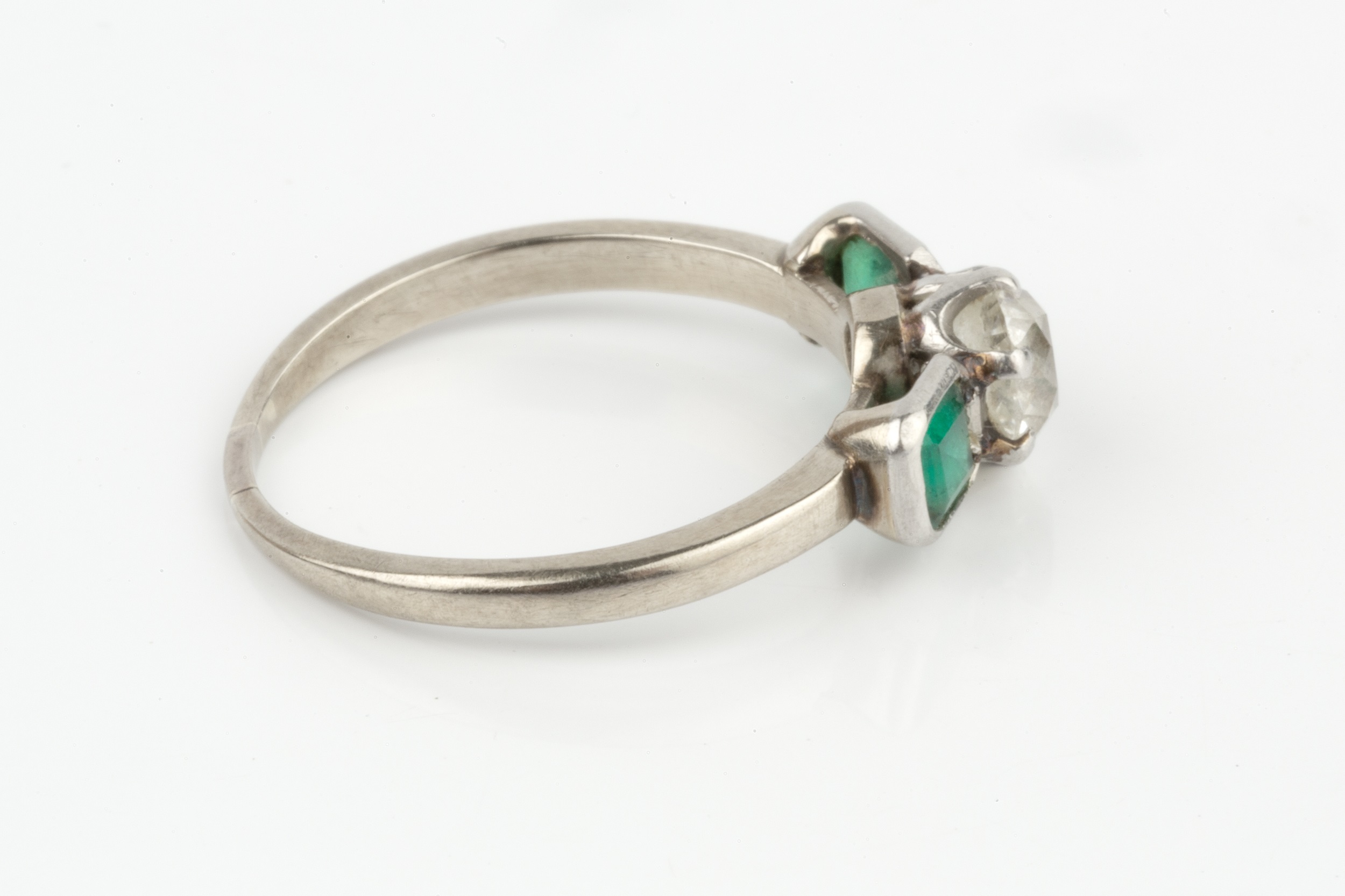 A diamond and emerald three stone ring, the central old-cut diamond in claw setting, between two - Image 3 of 4
