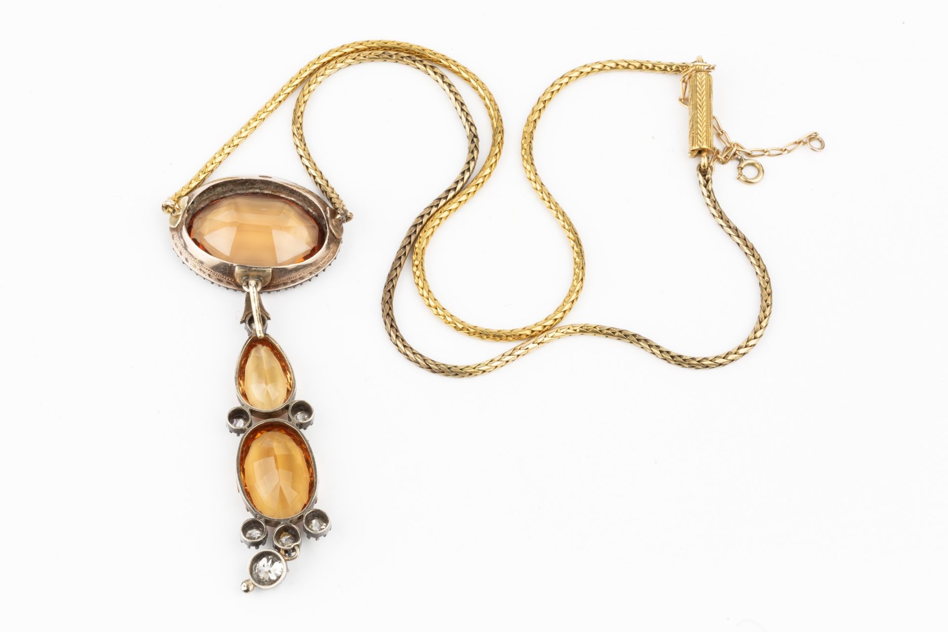 A topaz and diamond pendant, the principal oval stone of orange colour within a border of old cut - Bild 2 aus 2