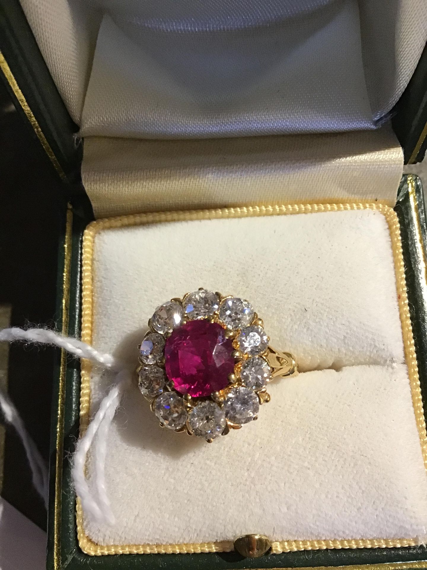 A ruby and diamond cluster ring, the central oval cut ruby within a border of ten old brilliant - Bild 6 aus 14