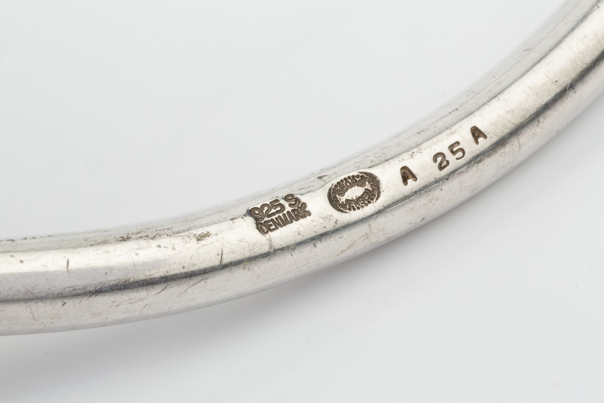 A Danish silver necklet by Georg Jensen, formed of two plain curved sections with loop hinge, no. - Bild 3 aus 3