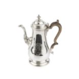 A George II silver baluster coffee pot, the hinged domed cover with urn finial, and having fluted