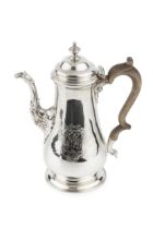 A George II silver baluster coffee pot, the hinged domed cover with urn finial, and having fluted