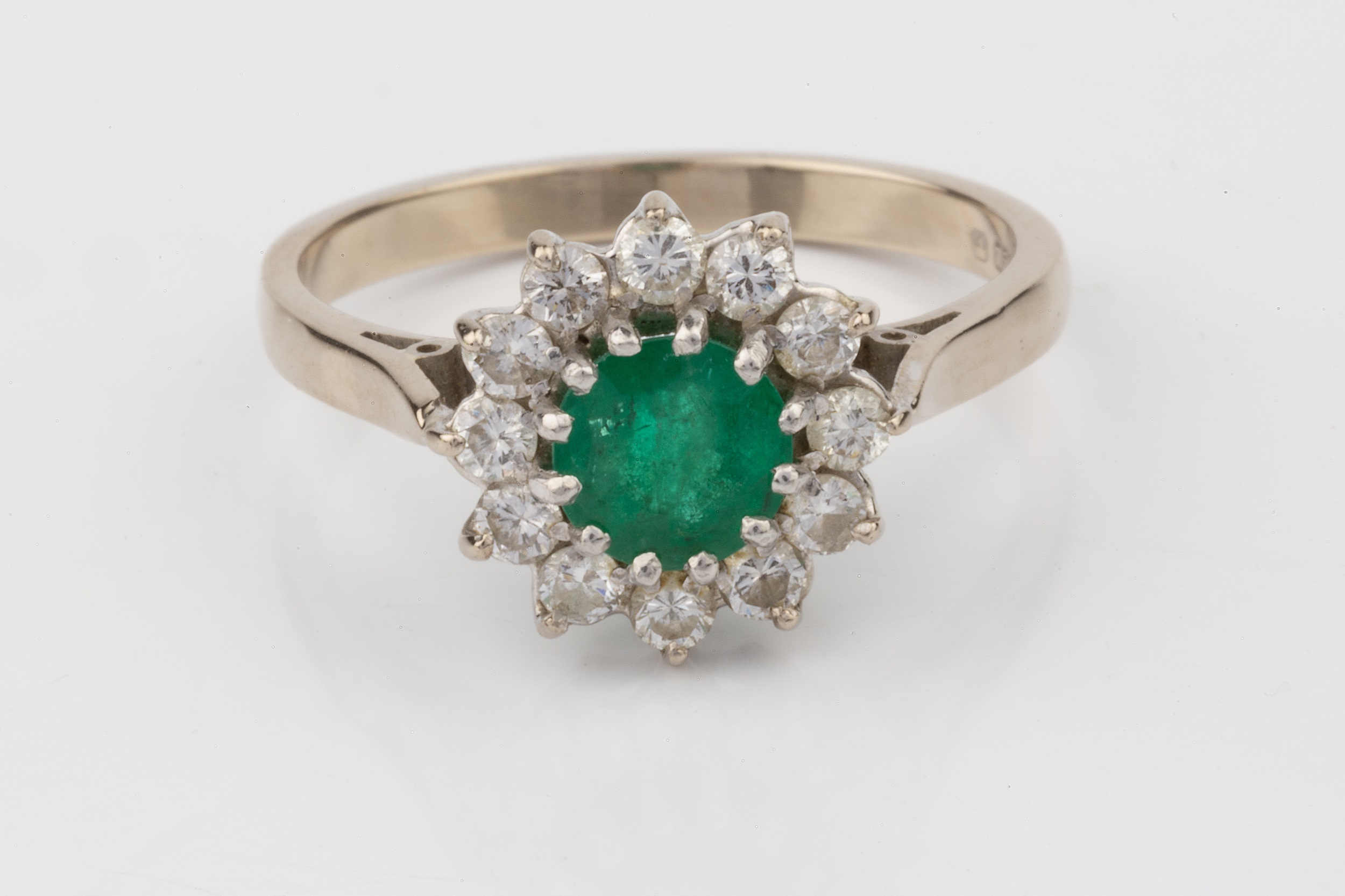 An emerald and diamond cluster ring, the central circular emerald within a border of twelve - Image 2 of 3