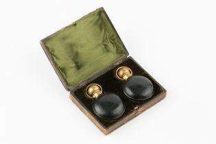 A pair of late Victorian green leather cased scent bottles, with gilt metal mounts, 6cm high in