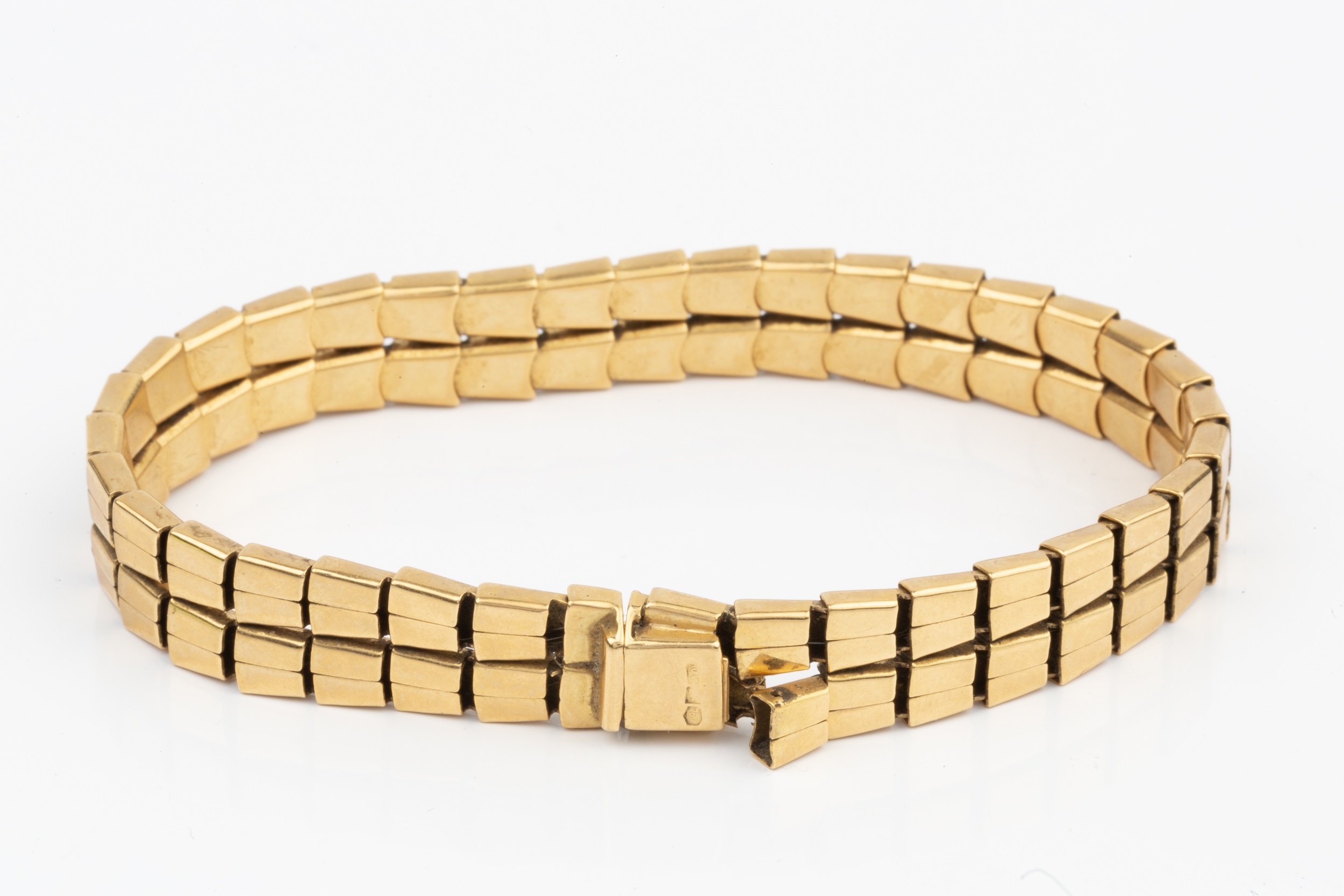 An 18ct gold bracelet, composed of two rows of flexible tapered rectangular links, the clasp stamped - Image 2 of 2