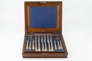 A set of twelve mid Victorian silver dessert knives and forks, with engraved blades, and beaded