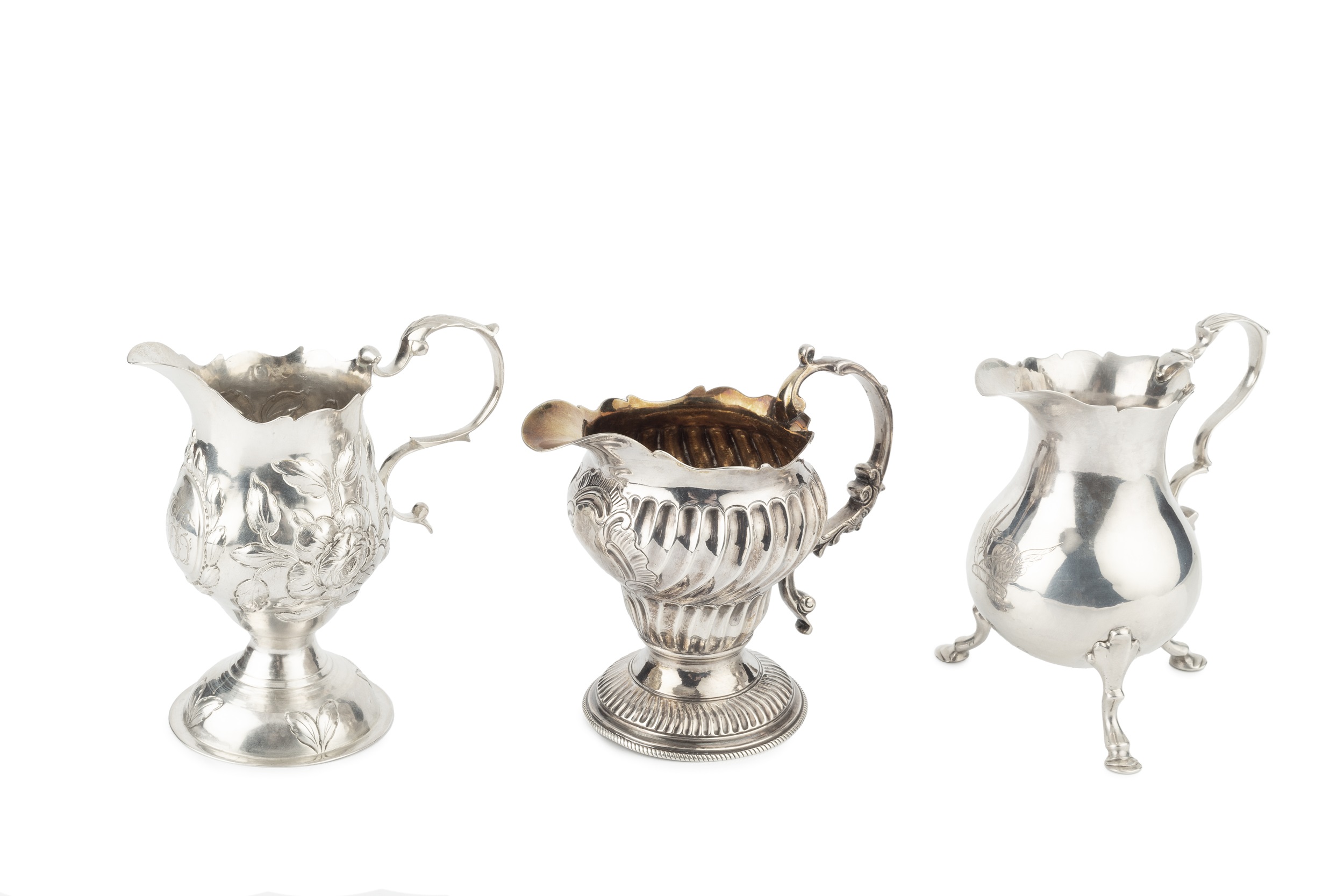 A George II silver cream jug, of baluster form with scroll handle and pad feet, by William Skeen,