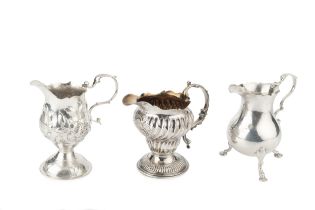 A George II silver cream jug, of baluster form with scroll handle and pad feet, by William Skeen,