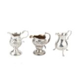 A George II silver cream jug, of baluster form with scroll handle and pad feet, by William Skeen,