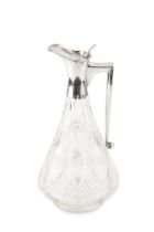 A George V silver mounted cut glass claret jug, the shaped body with panels of hobnail cut