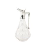 A George V silver mounted cut glass claret jug, the shaped body with panels of hobnail cut