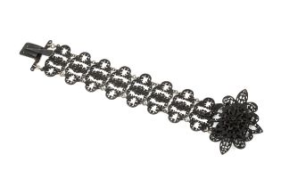 A Berlin ironwork bracelet, composed of a series of openwork lobed gothic plaques, the clasp centred
