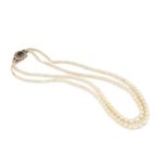 A twin strand graduated cultured pearl necklace, with shaped 9ct gold clasp centred with a red stone