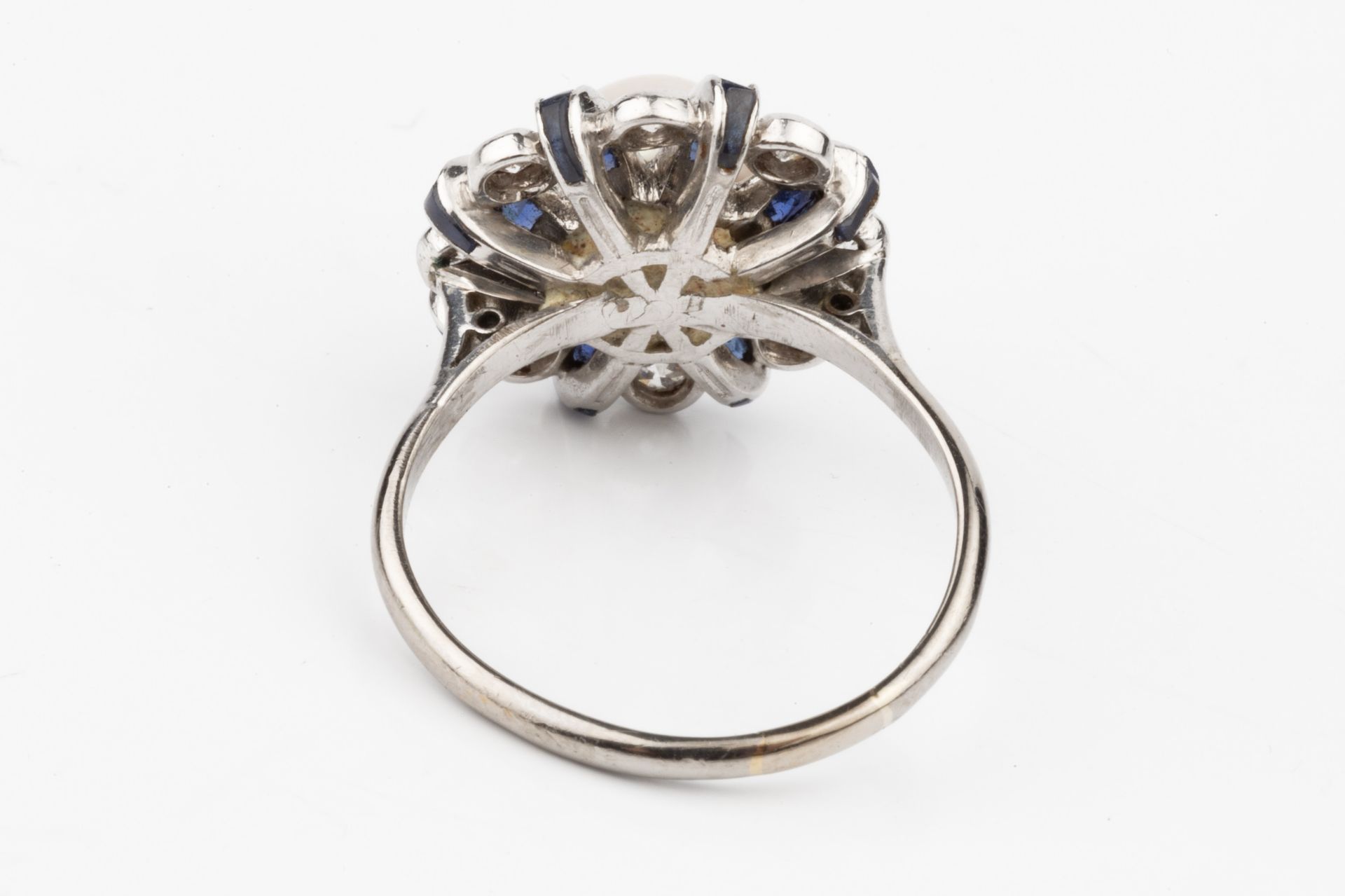A diamond, sapphire and cultured pearl dress ring, the central pearl (untested) set within a - Image 2 of 4