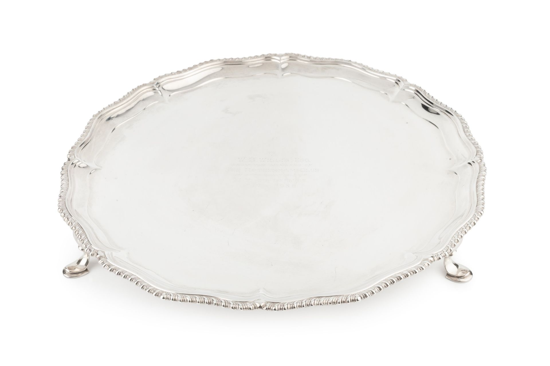 A late Victorian silver salver, with shaped and gadrooned border, on pad feet, later presentation