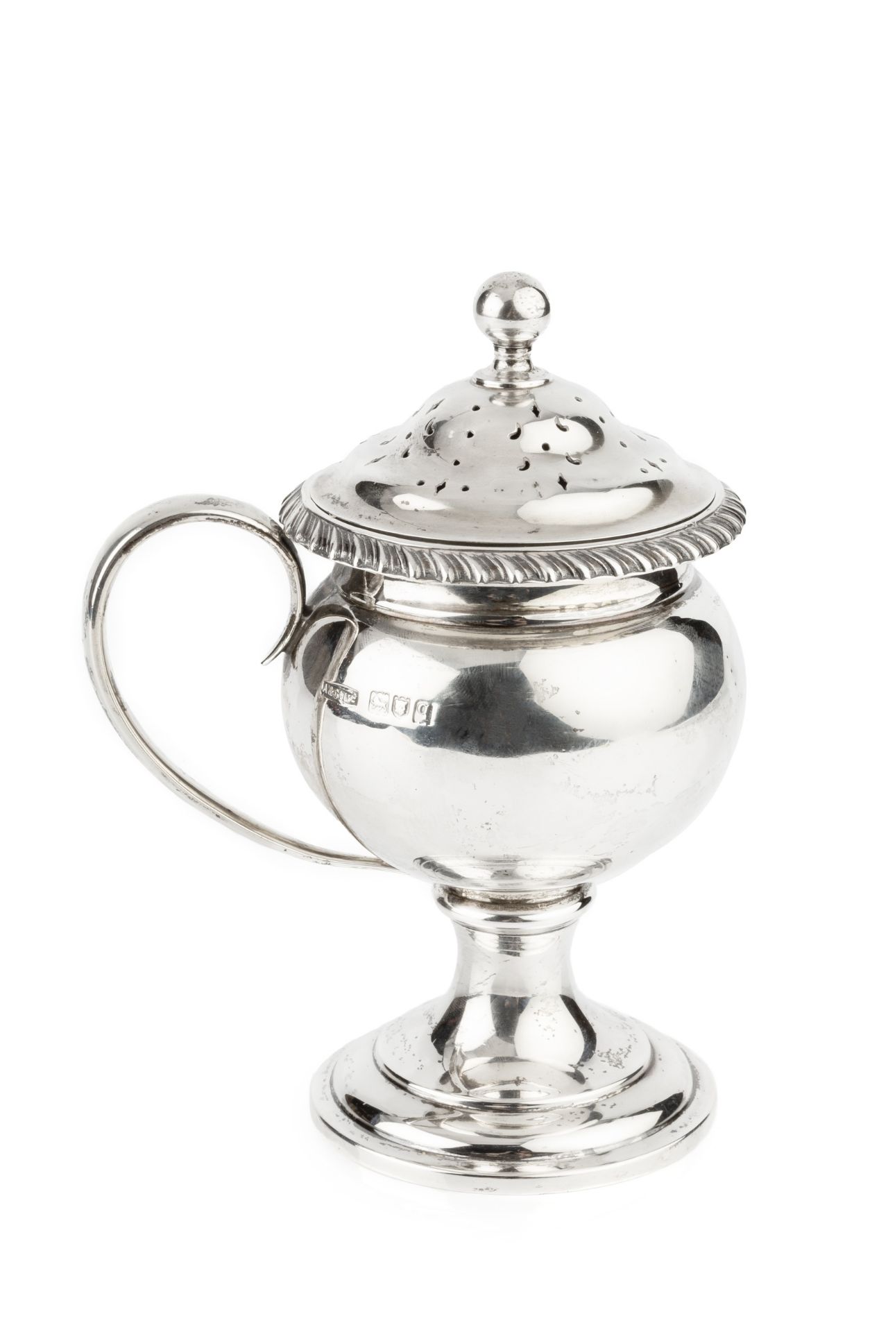 A George V silver sugar sifter, with gadrooned border, rounded body, side handle and circular