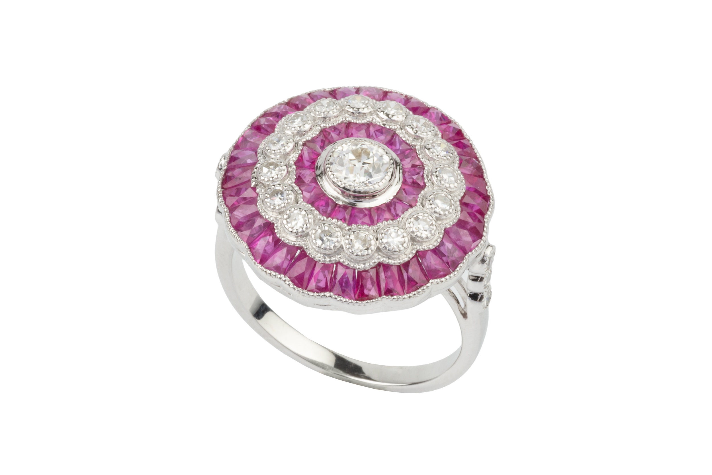 A ruby and diamond cocktail ring, of target design, centred with an old cut diamond within a