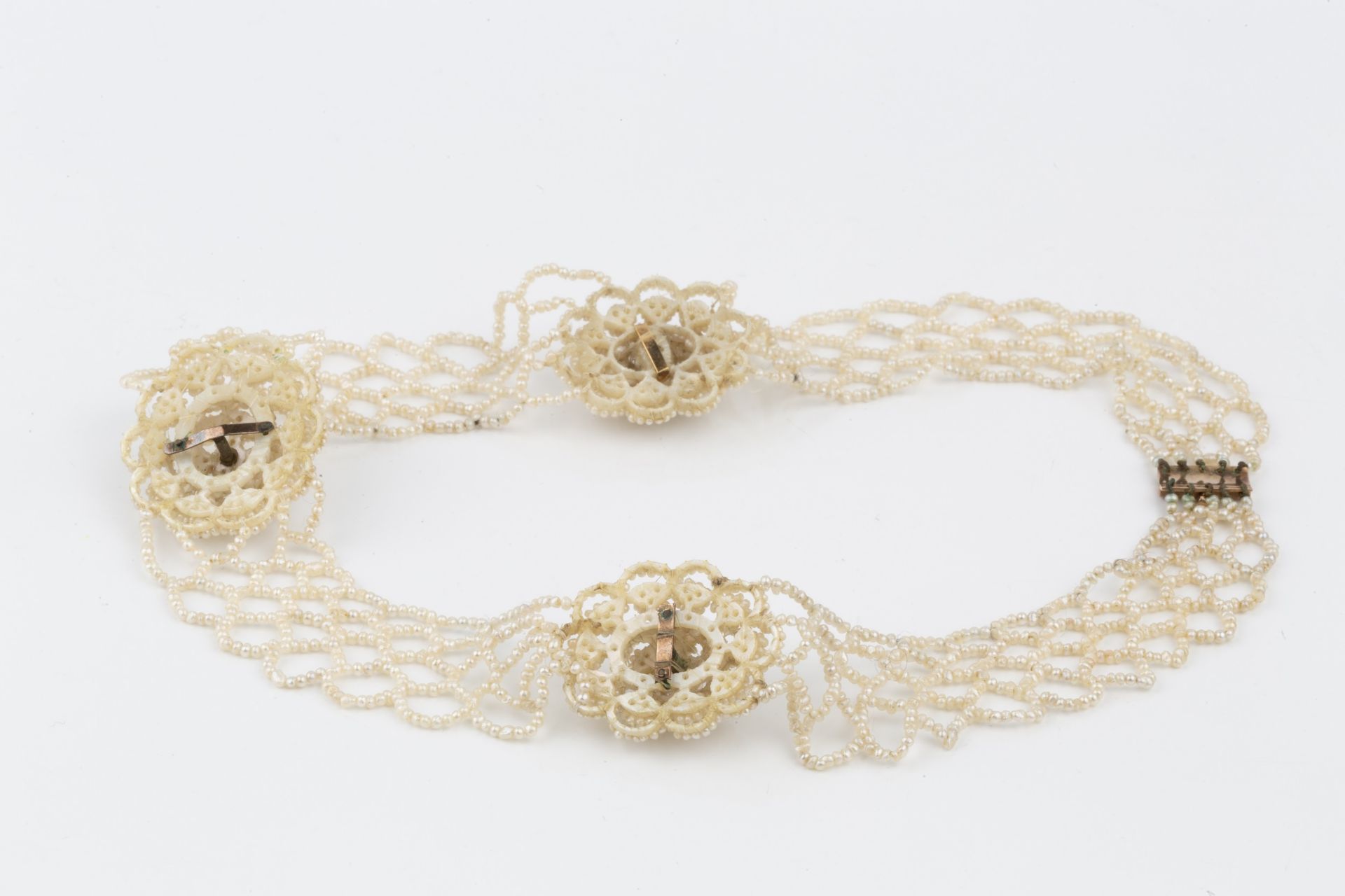 An early 19th century seed pearl collar, comprising three mother of pearl panels with raised - Bild 2 aus 2