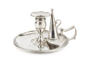 A George III silver chamberstick, with gadrooned borders, shaped angular handle and conical