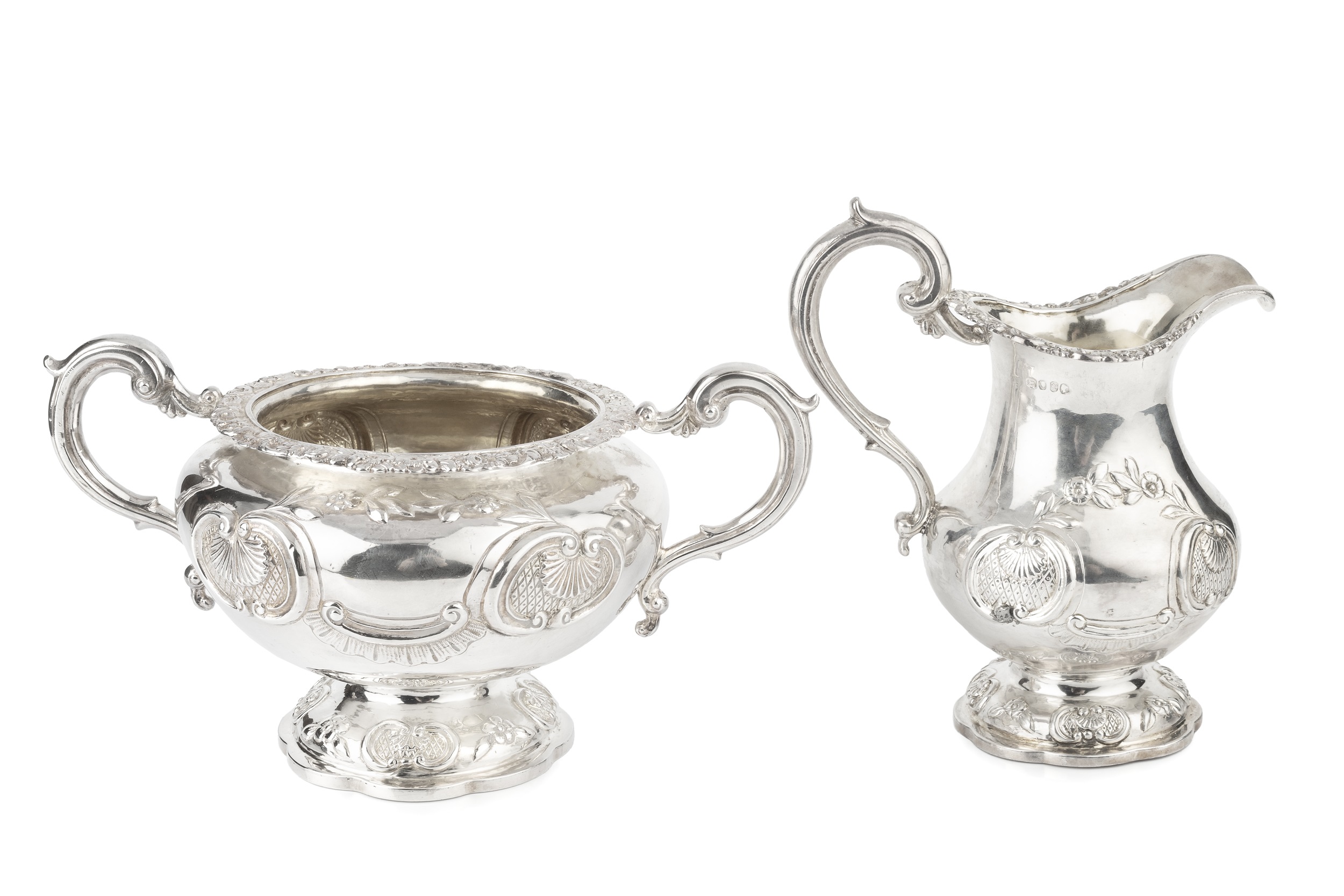 An early Victorian silver twin handled sucrier, and matching milk jug, with floral, scallop and C-