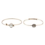 A diamond set bangle, the old brilliant cut stones set in a flowerhead cluster design on an