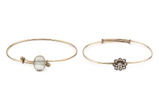 A diamond set bangle, the old brilliant cut stones set in a flowerhead cluster design on an