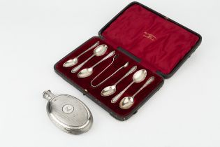 A mid Victorian silver hip flask, of oval form, with engine turned decoration reserving a crest to