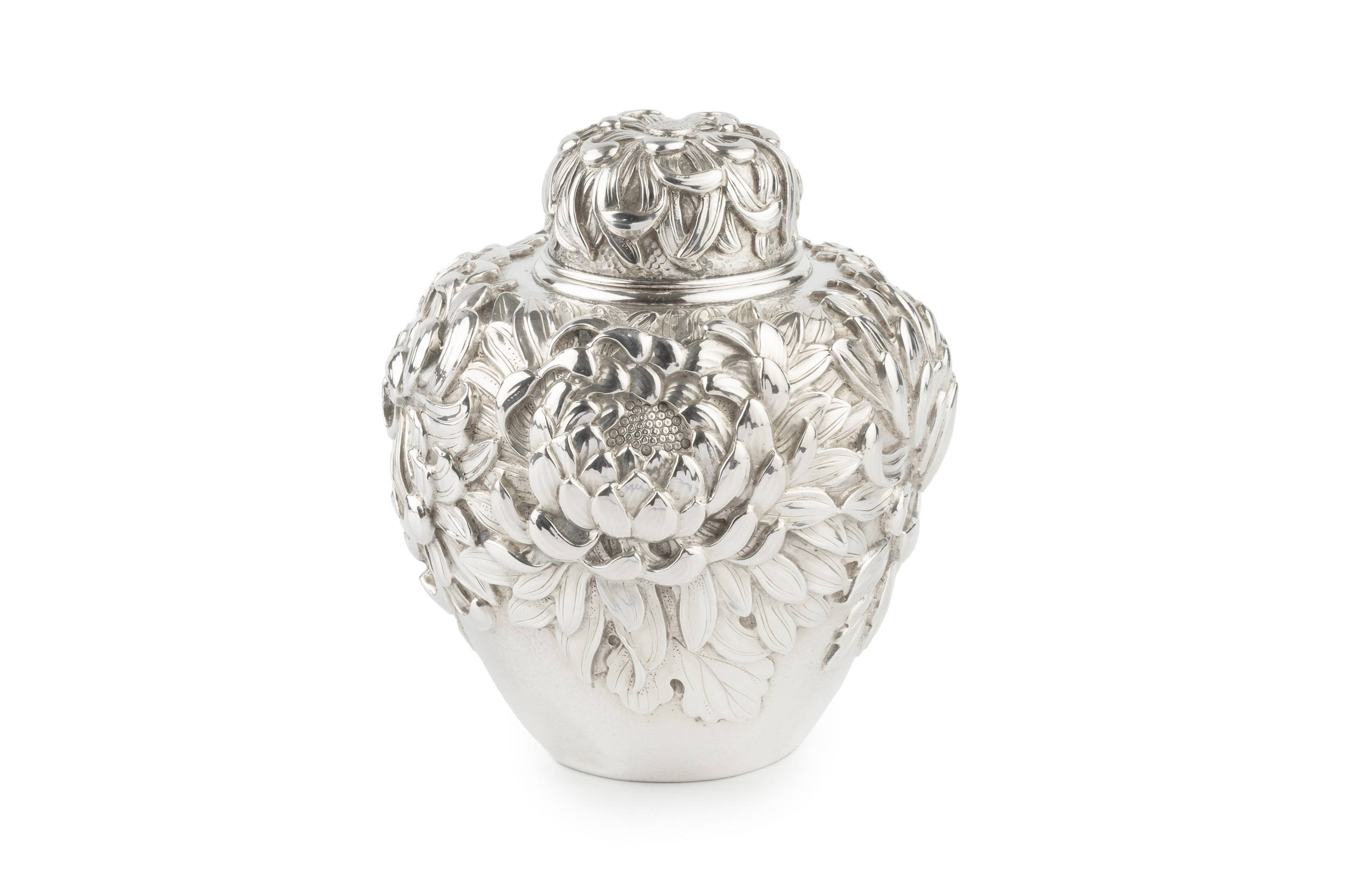 A late 19th/early 20th century Japanese silver tea caddy, of ovoid form, deeply embossed with