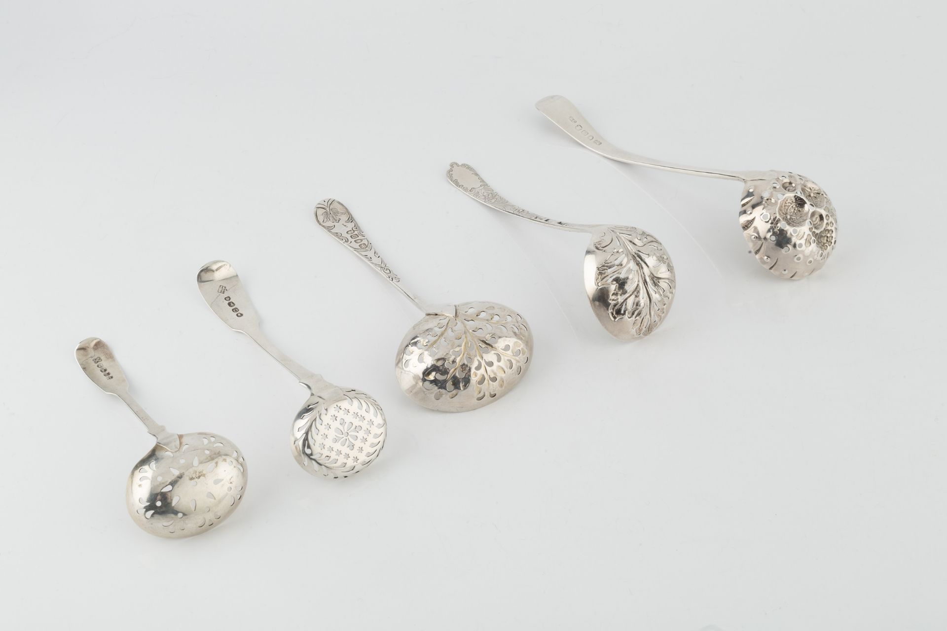 A George III silver sifter spoon, with foliate embossed and engraved pierced bowl, and foliate - Image 2 of 2