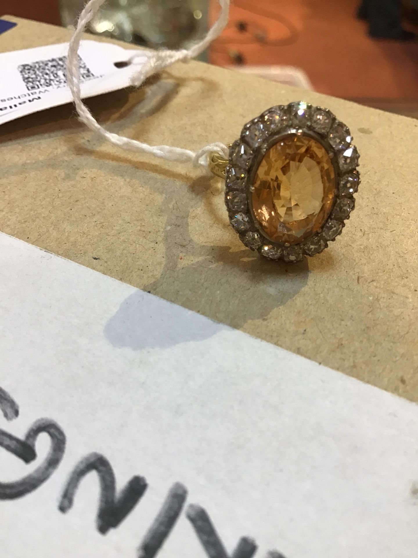 A topaz and diamond cluster ring, the oval central orange-brown topaz within a border of seventeen - Image 7 of 8