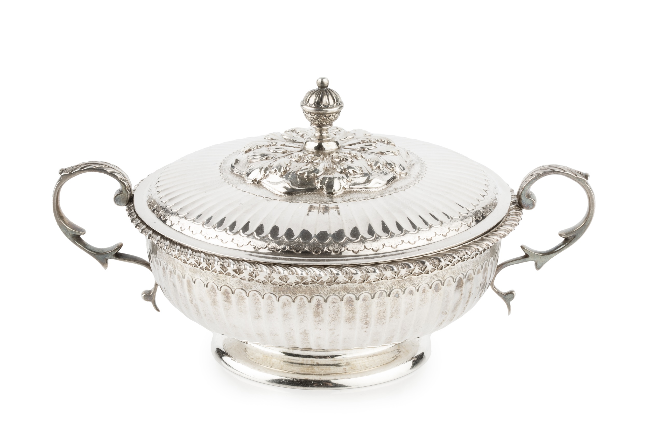 A George V silver twin handled shallow bowl and cover, with gadrooned border, fluted decoration,