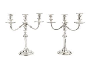 A pair of silver three light candelabra, the detachable branches with reeded arms and gadrooned drip