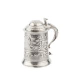 A George III silver tankard, the girdled body and domed hinged cover later embossed with flowers and