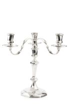 A silver three light candelabrum, the detachable branches with shaped arms, faceted nozzles and