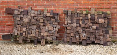 A pair of large teak garden blockwork panels