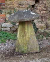 An old, weathered staddle stone