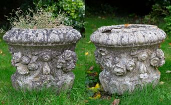 A pair of cast reconstituted stone planters or urn tops