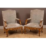 A pair of French Rococo-style open armchairs