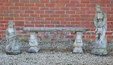 A garden bench and two female sculptures