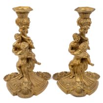 A pair of French gilt candlesticks after a design by Meissonnier