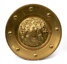 A brass armorial alms dish