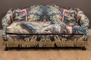 A sofa with verdure tapestry style upholstery